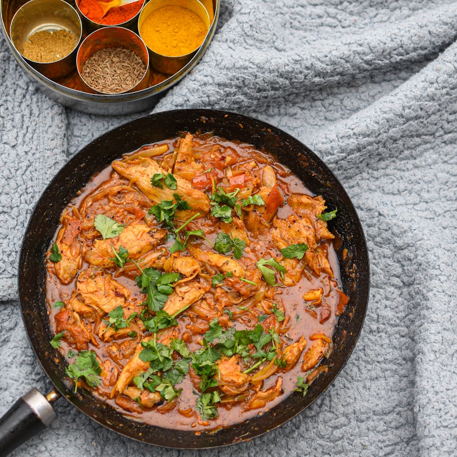 A tiffin lunch laid out with curry, rice and onion